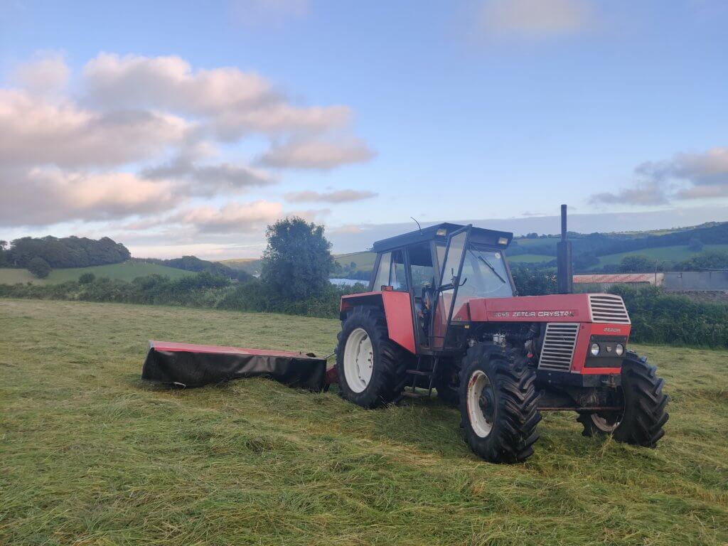 Zetor Crystal 12045 with Vicon mower cutting grass for hay in Cornwall